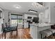Bright kitchen features white cabinets, granite countertops, stainless steel appliances, and a dining area with a window at 35 Vauxhall Ct, Youngsville, NC 27596
