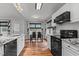 Bright kitchen features white cabinets, granite countertops, stainless steel appliances, and a dining area with large windows at 35 Vauxhall Ct, Youngsville, NC 27596