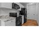 Modern kitchen with white cabinets, granite counters, and stainless steel appliances including range, microwave, and refrigerator at 35 Vauxhall Ct, Youngsville, NC 27596