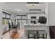 Open-concept kitchen and dining area with white cabinets, granite countertops, stainless appliances, and stylish pendant lighting at 35 Vauxhall Ct, Youngsville, NC 27596