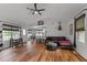 Spacious living room with laminate floors, a ceiling fan, comfortable seating, and views to the kitchen at 35 Vauxhall Ct, Youngsville, NC 27596