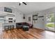 Cozy living room with wood-look floors, vaulted ceiling, and seamless transition to the kitchen area with a breakfast bar at 35 Vauxhall Ct, Youngsville, NC 27596