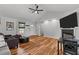 Bright living room featuring hardwood floors, vaulted ceilings, and a cozy fireplace at 35 Vauxhall Ct, Youngsville, NC 27596