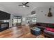 Open living area with high ceilings, wood floors, fireplace, modern furniture and decor, and kitchen view at 35 Vauxhall Ct, Youngsville, NC 27596