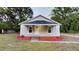 Charming home featuring a cozy front porch, gray siding, and a well-manicured lawn at 3610 Hawkins Ave, Sanford, NC 27330