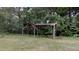 Outbuilding located on the property surrounded by mature trees and greenery at 3610 Hawkins Ave, Sanford, NC 27330