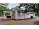 Rear exterior with a wooden patio, gray siding, and a large, grassy yard at 3610 Hawkins Ave, Sanford, NC 27330