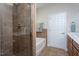 Neutral bathroom with glass shower, soaking tub, and ample counter space at 3827 Heritage Spring Circle Cir, Wake Forest, NC 27587