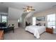 This bright bedroom is complemented by a ceiling fan, neutral carpet, and natural light at 3827 Heritage Spring Circle Cir, Wake Forest, NC 27587