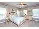 Cozy bedroom features a queen-sized bed, ceiling fan, and natural light from the window at 3827 Heritage Spring Circle Cir, Wake Forest, NC 27587