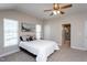 This bedroom has neutral walls, a fan, and an ensuite bathroom at 3827 Heritage Spring Circle Cir, Wake Forest, NC 27587