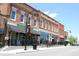Street-level view of charming brick storefronts with awnings and inviting storefronts at 3827 Heritage Spring Circle Cir, Wake Forest, NC 27587