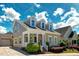 Charming two-story home featuring a welcoming front porch, dormer windows and well-manicured landscaping at 3827 Heritage Spring Circle Cir, Wake Forest, NC 27587