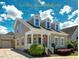 Charming two-story home with dormer windows, a welcoming front porch, and beautifully landscaped front yard at 3827 Heritage Spring Circle Cir, Wake Forest, NC 27587