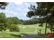 Scenic view of the golf course with lush greenery, sand traps, and blue skies at 3827 Heritage Spring Circle Cir, Wake Forest, NC 27587
