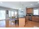 Eat-in kitchen with hardwood floors and an island open to the dining area at 3827 Heritage Spring Circle Cir, Wake Forest, NC 27587