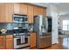 Updated kitchen featuring stainless steel appliances, granite countertops, and hardwood floors at 3827 Heritage Spring Circle Cir, Wake Forest, NC 27587