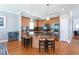 Bright kitchen featuring a large island with seating, stainless steel appliances, and hardwood floors at 3827 Heritage Spring Circle Cir, Wake Forest, NC 27587