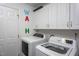 Well-organized laundry room with modern washer and dryer units, storage cabinets at 3827 Heritage Spring Circle Cir, Wake Forest, NC 27587