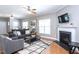 Bright living room features a fireplace, hardwood floors, and large windows at 3827 Heritage Spring Circle Cir, Wake Forest, NC 27587