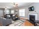 Cozy living room with hardwood floors, fireplace, ceiling fan, and comfortable seating at 3827 Heritage Spring Circle Cir, Wake Forest, NC 27587