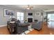 Cozy living room with hardwood floors, fireplace, ceiling fan, and comfortable seating at 3827 Heritage Spring Circle Cir, Wake Forest, NC 27587