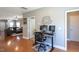 Home office with dual monitors, ergonomic chair, adjacent to an inviting living room at 3827 Heritage Spring Circle Cir, Wake Forest, NC 27587