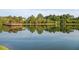 Picturesque pond view with lush greenery, a wooden gazebo, and reflections of the surrounding landscape at 3827 Heritage Spring Circle Cir, Wake Forest, NC 27587