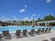 Beautiful, large swimming pool with marked lanes, sun loungers, and a clubhouse in the background at 3827 Heritage Spring Circle Cir, Wake Forest, NC 27587