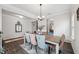 Bright dining room featuring an elegant chandelier, a rustic wood table, and stylish blue and pink upholstered chairs at 3901 Bluffwind Dr, Raleigh, NC 27603