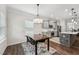 A small table, modern light fixture and stainless appliances are a few steps from the dining room at 3901 Bluffwind Dr, Raleigh, NC 27603