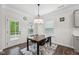 Dining room features a modern light fixture, a small table, and a door leading to the outside at 3901 Bluffwind Dr, Raleigh, NC 27603