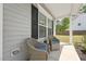 Inviting front porch with two wicker chairs and blue cushions, perfect for relaxing and enjoying the neighborhood view at 3901 Bluffwind Dr, Raleigh, NC 27603