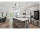 Kitchen features a large island, stainless appliances, white subway tile backsplash, and grey cabinets at 3901 Bluffwind Dr, Raleigh, NC 27603