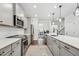 Modern kitchen with stainless steel appliances, a large center island with bar seating, and stylish pendant lighting at 3901 Bluffwind Dr, Raleigh, NC 27603