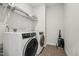 Well-lit laundry room with modern washer, dryer and storage shelves at 3901 Bluffwind Dr, Raleigh, NC 27603