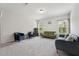 Bright living room featuring neutral carpeting, providing a flexible space for entertaining at 3901 Bluffwind Dr, Raleigh, NC 27603