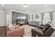 Spacious living room with stone accent wall, comfortable seating, decorative rug, and a large screen TV at 3901 Bluffwind Dr, Raleigh, NC 27603