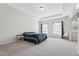 Spacious main bedroom showcasing a tray ceiling and abundant natural light at 3901 Bluffwind Dr, Raleigh, NC 27603