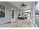 Cozy screened porch with comfortable seating, ceiling fan, and floral rug at 3901 Bluffwind Dr, Raleigh, NC 27603