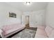Sitting room with two pink couches, grey rug, dark vinyl flooring, and natural lighting at 3901 Bluffwind Dr, Raleigh, NC 27603