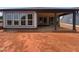 A covered patio in the backyard of the house with an unfinished red clay lot at 40 Wabash St, Pittsboro, NC 27312