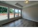Serene bedroom with hardwood floors, large windows offering scenic views, and tray ceiling at 40 Wabash St, Pittsboro, NC 27312