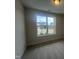 Bright bedroom with neutral carpet and a large window offering scenic neighborhood views at 40 Wabash St, Pittsboro, NC 27312