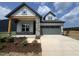 Charming single-Gathering home featuring stone accents and a spacious two-car garage at 40 Wabash St, Pittsboro, NC 27312