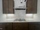 Kitchen features stainless steel range hood and tile backsplash at 40 Wabash St, Pittsboro, NC 27312