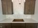 Close up shot of a kitchen with wood cabinets, quartz countertops, and tile backsplash at 40 Wabash St, Pittsboro, NC 27312