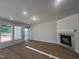 Bright living room with a fireplace, large windows, and neutral paint, offering a cozy space for relaxation at 40 Wabash St, Pittsboro, NC 27312