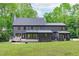 Expansive backyard featuring a large deck, screened porch, lush lawn, mature trees, and privacy at 401 Brinkman Ct, Raleigh, NC 27614