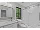 Bright bathroom featuring white marble vanity and updated shower with clear glass door at 401 Brinkman Ct, Raleigh, NC 27614